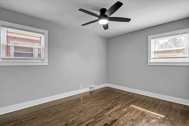 9007 S Cregier Ave, Chicago, IL 60617 - unfurnished room with healthy amount of natural light, dark wood-type flooring, and ceiling fan