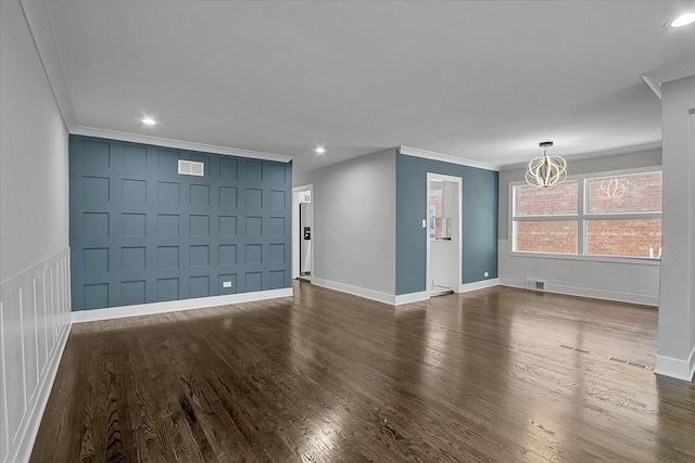 9007 S Cregier Ave, Chicago, IL 60617 - unfurnished living room with a decorative wall, a chandelier, crown molding, dark wood-style flooring, and recessed lighting