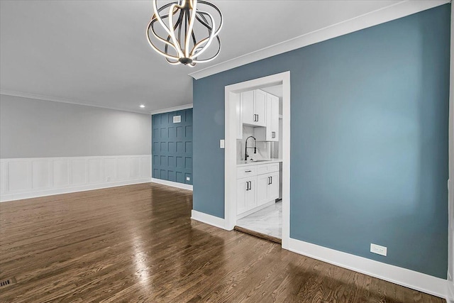 9007 S Cregier Ave, Chicago, IL 60617 - unfurnished room with ornamental molding, a chandelier, and dark wood-style floors