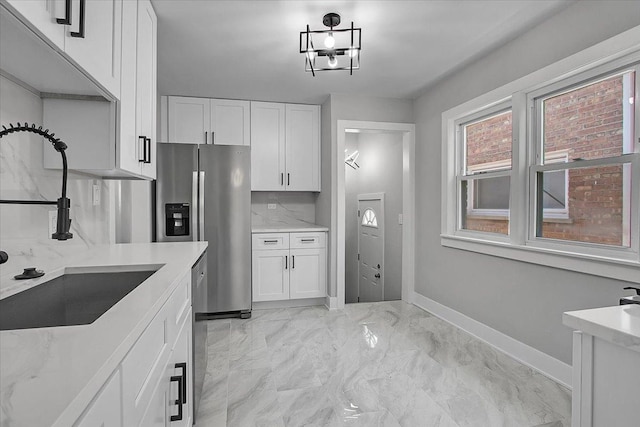 9007 S Cregier Ave, Chicago, IL 60617 - kitchen with stainless steel appliances, white cabinets, light marble finish floors, and light stone countertops