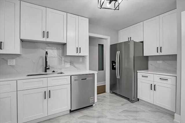 9007 S Cregier Ave, Chicago, IL 60617 - kitchen with appliances with stainless steel finishes, light marble finish flooring, white cabinets, and tasteful backsplash
