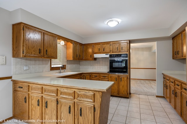 13938 S Trails End Dr, Homer Glen, IL 60491 - kitchen featuring oven, a peninsula, brown cabinetry, light countertops, and decorative backsplash
