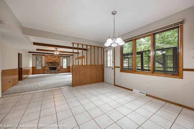 13938 S Trails End Dr, Homer Glen, IL 60491 - empty room featuring healthy amount of natural light, a wainscoted wall, a brick fireplace, a chandelier, and wooden walls