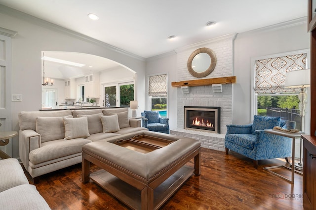 2135 Kenton Ln, Libertyville, IL 60048 - living area featuring arched walkways, a fireplace, dark wood-style flooring, crown molding, and recessed lighting