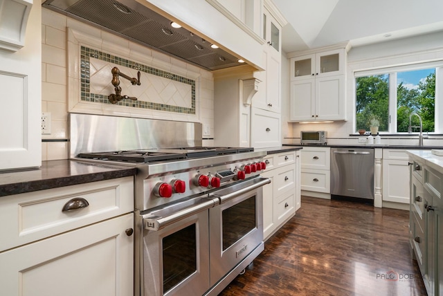 2135 Kenton Ln, Libertyville, IL 60048 - kitchen with stainless steel appliances, custom range hood, tasteful backsplash, glass insert cabinets, and dark wood-style floors