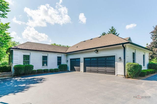 2135 Kenton Ln, Libertyville, IL 60048 - ranch-style home featuring a garage, driveway, and brick siding