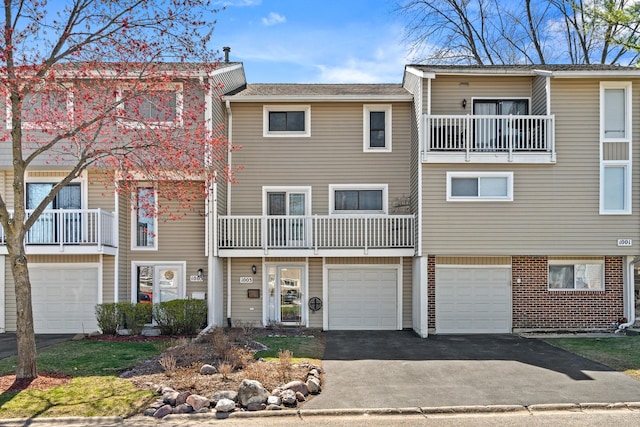 1003 Sandpiper Ct, Bartlett, IL 60103 - view of property featuring driveway, a garage, and a balcony