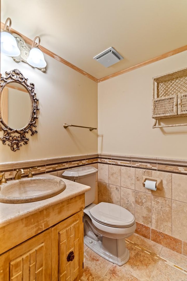 1003 Sandpiper Ct, Bartlett, IL 60103 - half bath featuring tile walls, a wainscoted wall, ornamental molding, and vanity