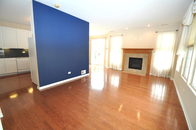 24952 Clare Cir, Manhattan, IL 60442 - unfurnished living room featuring a fireplace and light wood-style flooring