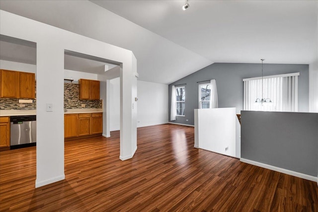 823 Symphony Dr, Aurora, IL 60504 - unfurnished living room featuring vaulted ceiling, dark wood-style floors, and a chandelier