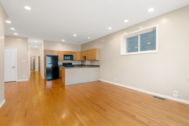 5028 W Lawrence Ave, Chicago, IL 60630 - kitchen featuring black appliances, dark countertops, a peninsula, recessed lighting, and light wood-type flooring