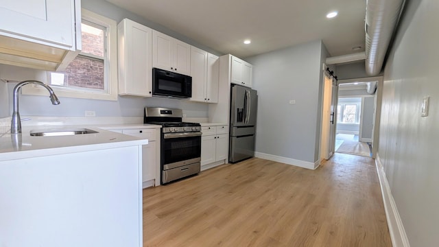 5028 W Lawrence Ave, Chicago, IL 60630 - kitchen with stainless steel appliances, light wood-style flooring, white cabinetry, light countertops, and recessed lighting