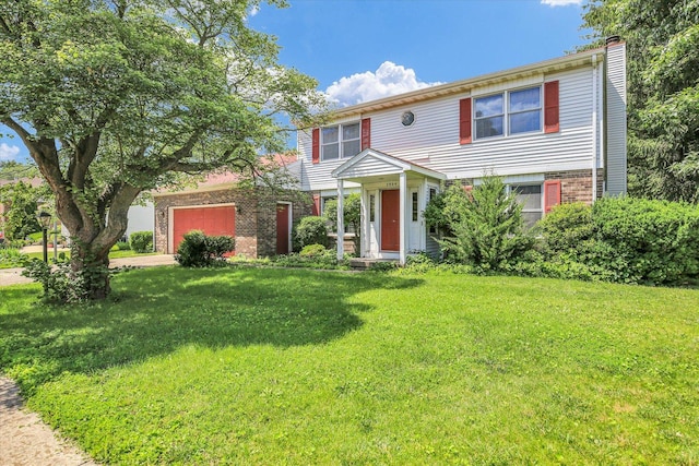 2904 Robeson Park Dr, Champaign, IL 61822 - colonial home with brick siding, a chimney, a front lawn, and a garage