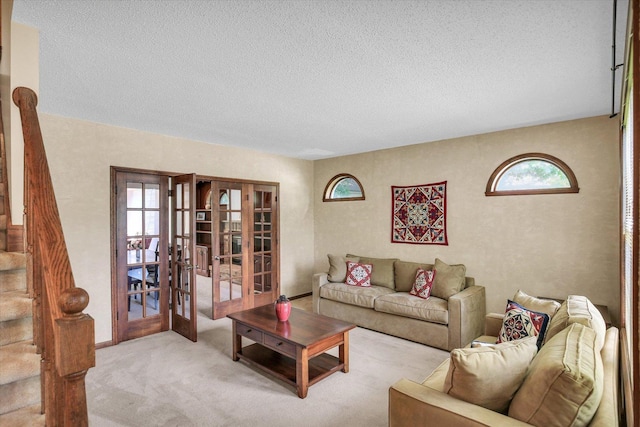 2904 Robeson Park Dr, Champaign, IL 61822 - living room featuring french doors, a textured ceiling, plenty of natural light, carpet floors, and stairway