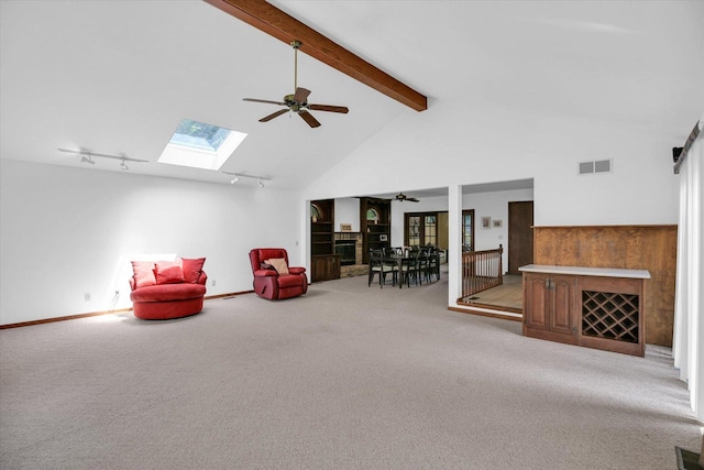 2904 Robeson Park Dr, Champaign, IL 61822 - sitting room with ceiling fan, beamed ceiling, light colored carpet, a skylight, and high vaulted ceiling