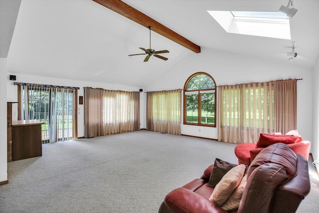 2904 Robeson Park Dr, Champaign, IL 61822 - living area featuring a skylight, beam ceiling, healthy amount of natural light, a ceiling fan, and carpet