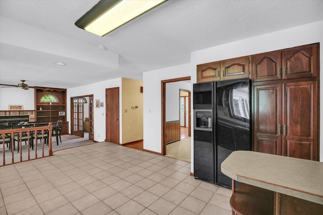 2904 Robeson Park Dr, Champaign, IL 61822 - kitchen featuring black fridge with ice dispenser, ceiling fan, a textured ceiling, light countertops, and french doors
