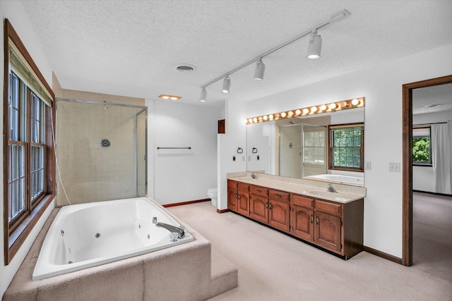 2904 Robeson Park Dr, Champaign, IL 61822 - full bath with a whirlpool tub, double vanity, an enclosed shower, a textured ceiling, and track lighting