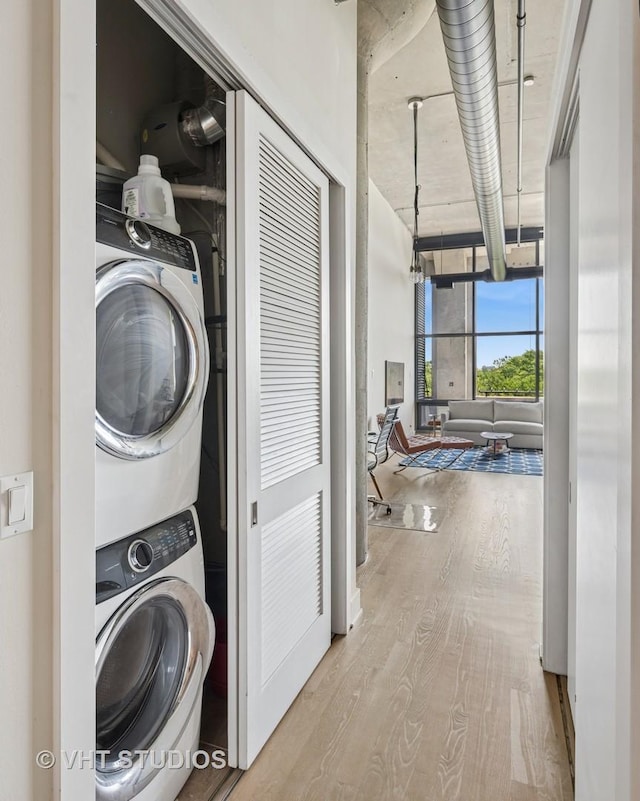 1800 W Grace St Unit 523, Chicago, IL 60613 - laundry area with estacked washer and dryer and wood finished floors
