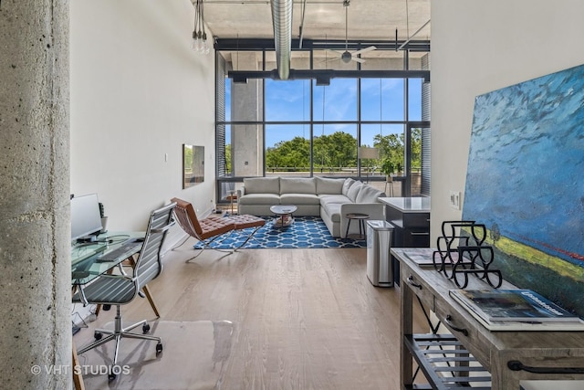 1800 W Grace St Unit 523, Chicago, IL 60613 - living area with a towering ceiling, wood finished floors, and ceiling fan