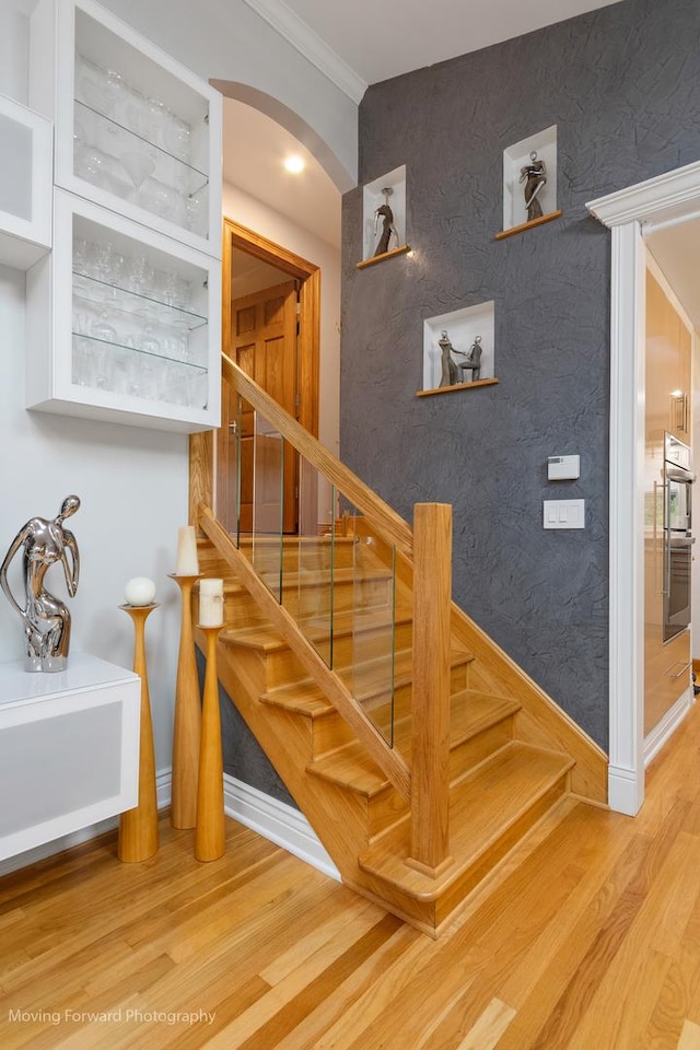 1145 S Chestnut Ave, Arlington Heights, IL 60005 - stairs with arched walkways, crown molding, and wood finished floors