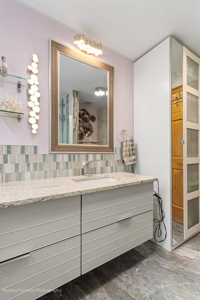 1145 S Chestnut Ave, Arlington Heights, IL 60005 - bathroom with vanity, tasteful backsplash, and marble finish flooring