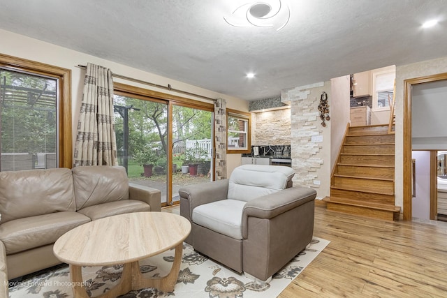 1145 S Chestnut Ave, Arlington Heights, IL 60005 - living room with stairs, light wood-style floors, a fireplace, a textured ceiling, and recessed lighting