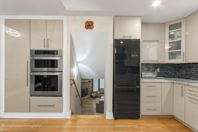 1145 S Chestnut Ave, Arlington Heights, IL 60005 - kitchen with freestanding refrigerator, stainless steel double oven, light wood-type flooring, and glass insert cabinets