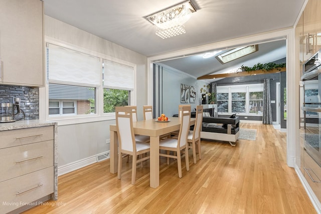 1145 S Chestnut Ave, Arlington Heights, IL 60005 - dining area featuring light wood finished floors, vaulted ceiling, and a chandelier
