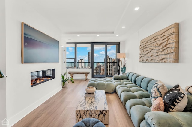 1560 N Sandburg Ter Unit 2810J, Chicago, IL 60610 - living room featuring wood finished floors, a multi sided fireplace, and recessed lighting