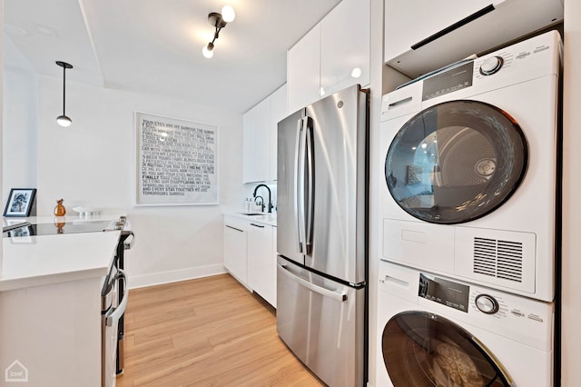 1560 N Sandburg Ter Unit 2810J, Chicago, IL 60610 - washroom with stacked washer / dryer and light wood-type flooring