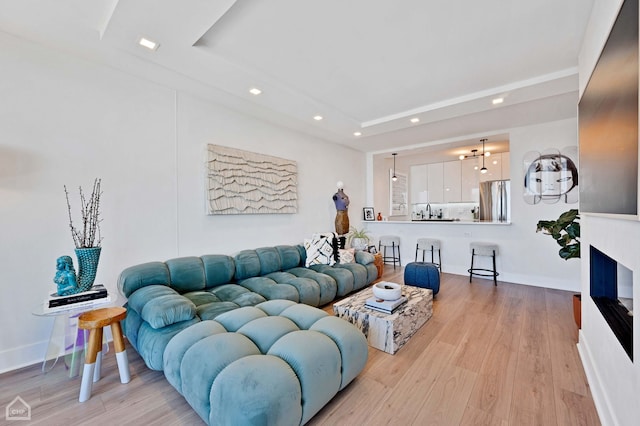 1560 N Sandburg Ter Unit 2810J, Chicago, IL 60610 - living room featuring recessed lighting, a raised ceiling, and light wood-style flooring