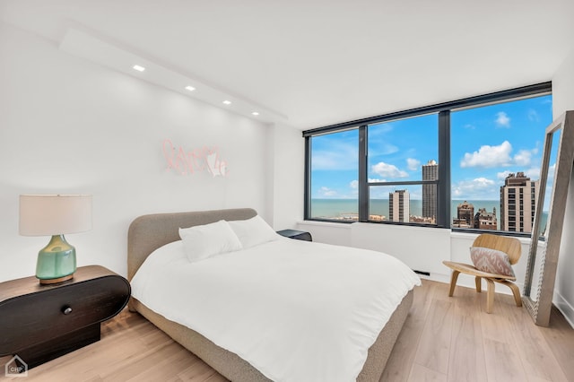 1560 N Sandburg Ter Unit 2810J, Chicago, IL 60610 - bedroom featuring recessed lighting, light wood-style flooring, and a view of city