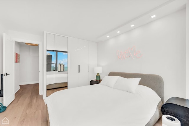 1560 N Sandburg Ter Unit 2810J, Chicago, IL 60610 - bedroom featuring recessed lighting, light wood-type flooring, and a closet