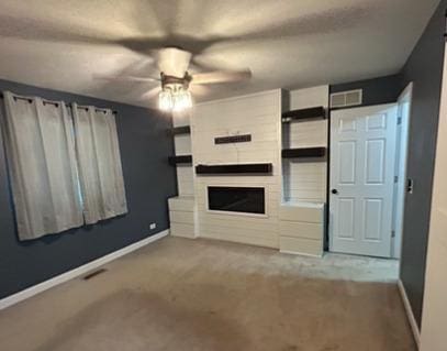 488 Fairview Dr Unit 0, Manhattan, IL 60442 - unfurnished living room with ceiling fan, carpet flooring, and a fireplace