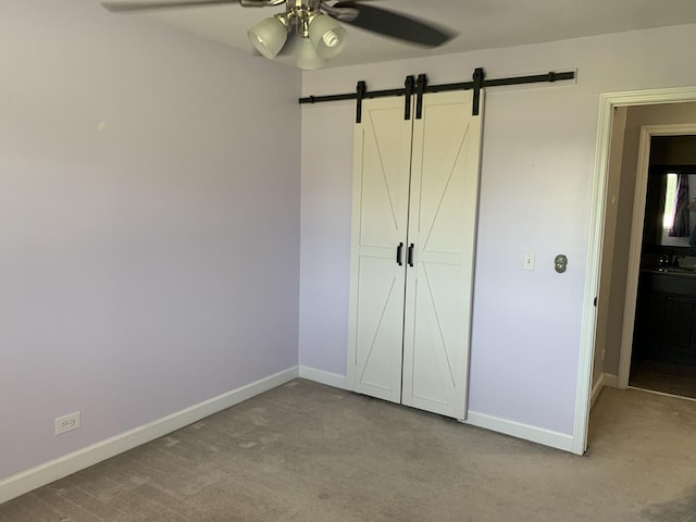 488 Fairview Dr Unit 0, Manhattan, IL 60442 - unfurnished bedroom featuring a barn door, carpet floors, and ceiling fan