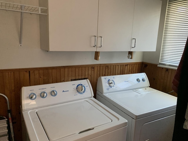 488 Fairview Dr Unit 0, Manhattan, IL 60442 - washroom featuring washing machine and dryer, wood walls, a wainscoted wall, and cabinet space