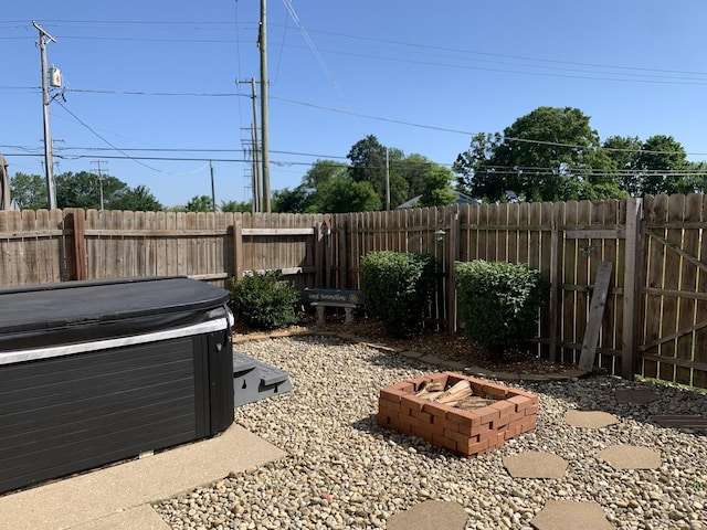 488 Fairview Dr Unit 0, Manhattan, IL 60442 - fenced backyard with a hot tub and an outdoor fire pit