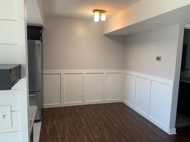 488 Fairview Dr Unit 0, Manhattan, IL 60442 - unfurnished dining area featuring a decorative wall, dark wood-style flooring, and wainscoting