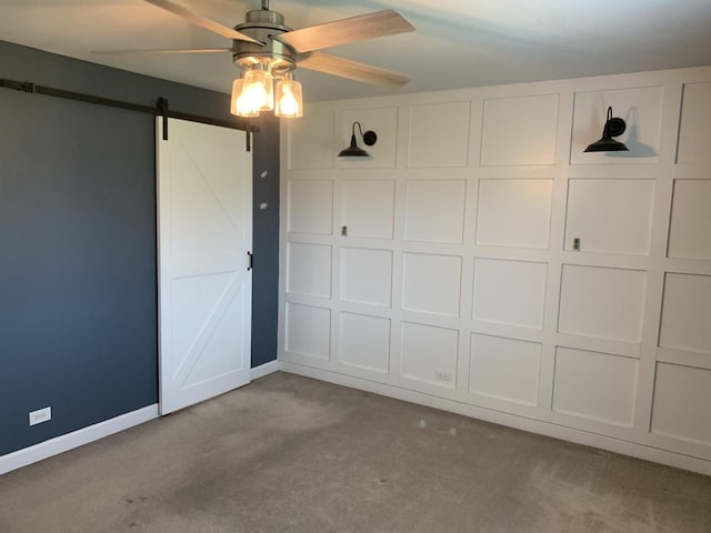 488 Fairview Dr Unit 0, Manhattan, IL 60442 - unfurnished bedroom with a barn door, carpet floors, and ceiling fan