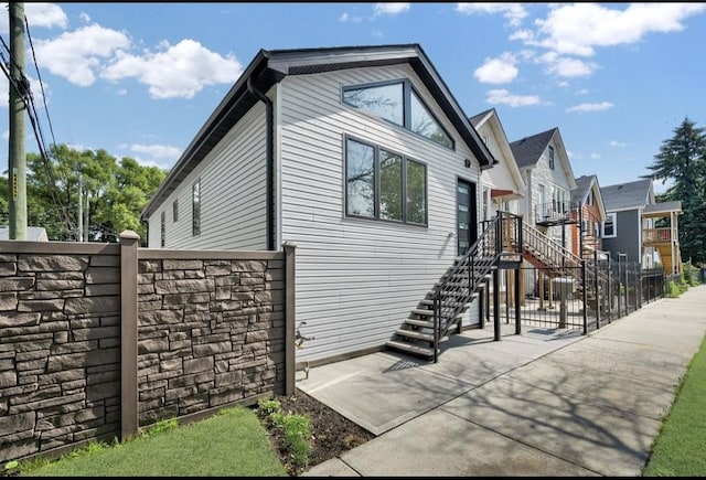 1444 W 49th Pl, Chicago, IL 60609 - view of side of home with a patio area, stairway, and stone siding