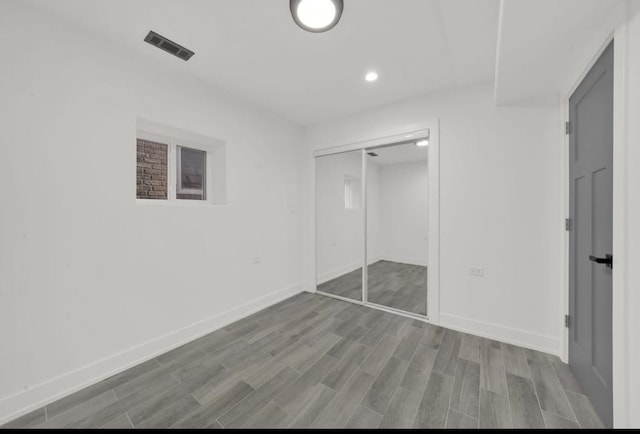 1444 W 49th Pl, Chicago, IL 60609 - unfurnished bedroom with wood finished floors, recessed lighting, and a closet
