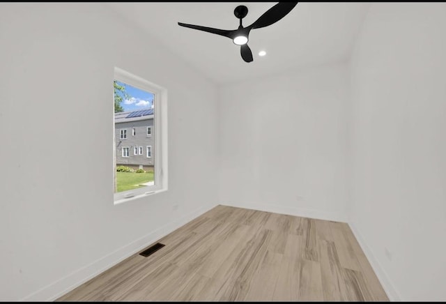 1444 W 49th Pl, Chicago, IL 60609 - unfurnished room featuring light wood-style floors and a ceiling fan