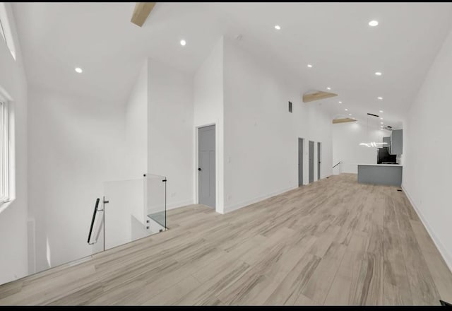 1444 W 49th Pl, Chicago, IL 60609 - unfurnished living room with high vaulted ceiling, recessed lighting, and light wood-style flooring