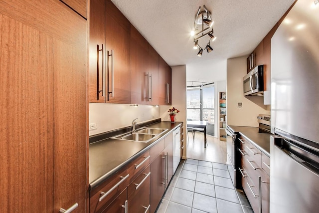 899 S Plymouth Ct Unit 1103, Chicago, IL 60605 - kitchen featuring stainless steel appliances, tile patterned floors, modern cabinets, a textured ceiling, and dark countertops