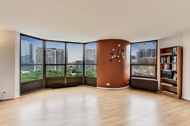 899 S Plymouth Ct Unit 1103, Chicago, IL 60605 - unfurnished room with wood finished floors, a city view, and healthy amount of natural light