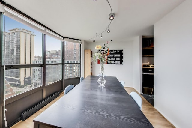 899 S Plymouth Ct Unit 1103, Chicago, IL 60605 - dining room featuring a view of city and light wood-style floors