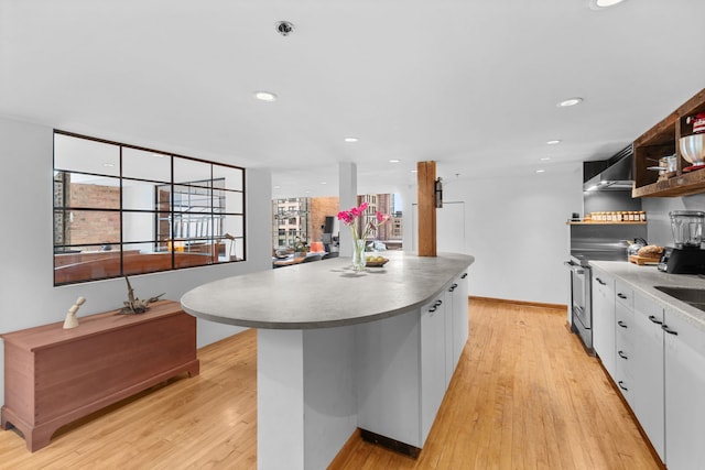 531 S Plymouth Ct Unit 602, Chicago, IL 60605 - kitchen with open shelves, white cabinetry, light wood-style flooring, wall chimney range hood, and stainless steel electric stove