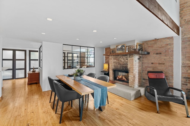 531 S Plymouth Ct Unit 602, Chicago, IL 60605 - dining area featuring a glass covered fireplace, hardwood / wood-style flooring, brick wall, and recessed lighting
