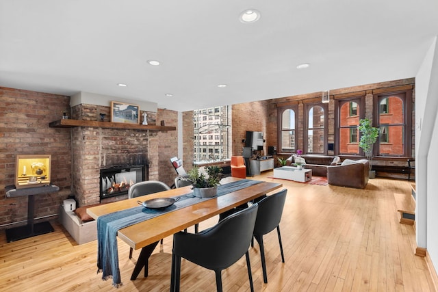 531 S Plymouth Ct Unit 602, Chicago, IL 60605 - dining space with brick wall, a brick fireplace, light wood-type flooring, and recessed lighting